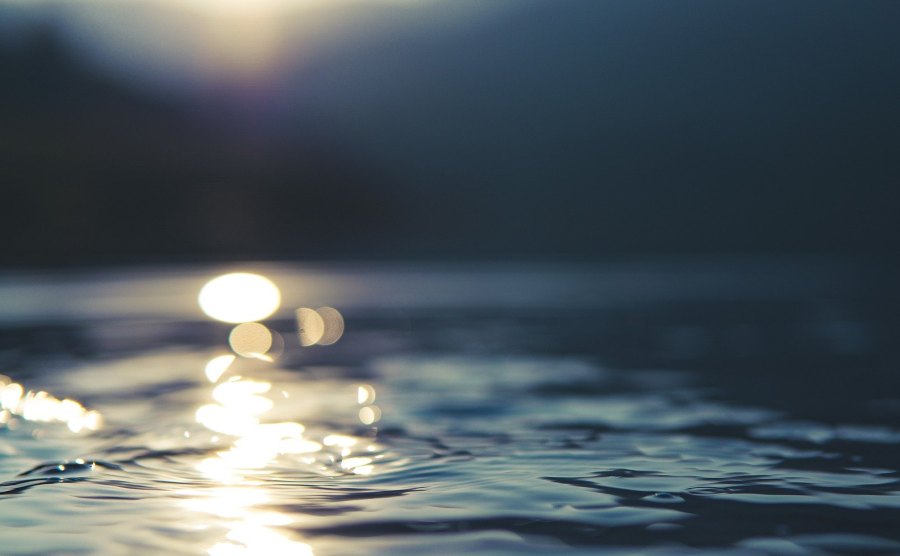 an up close view of water with some lens flare for drama